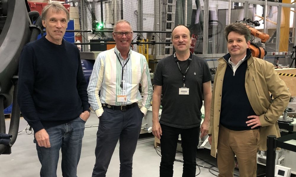 The four recipients of the 2026 Joseph W. Goodman Book Writing Award, Thomas Luhmann, Stuart Robson, Stephen Kyle, and Jan Boehm, standing in an industrial laboratory.