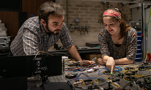 Two people in an optics and photonics lab at the University of Birmingham