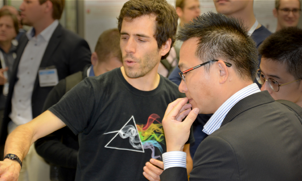 SPIE Optics + Optoelectronics participant talking with colleagues during technical and networking events