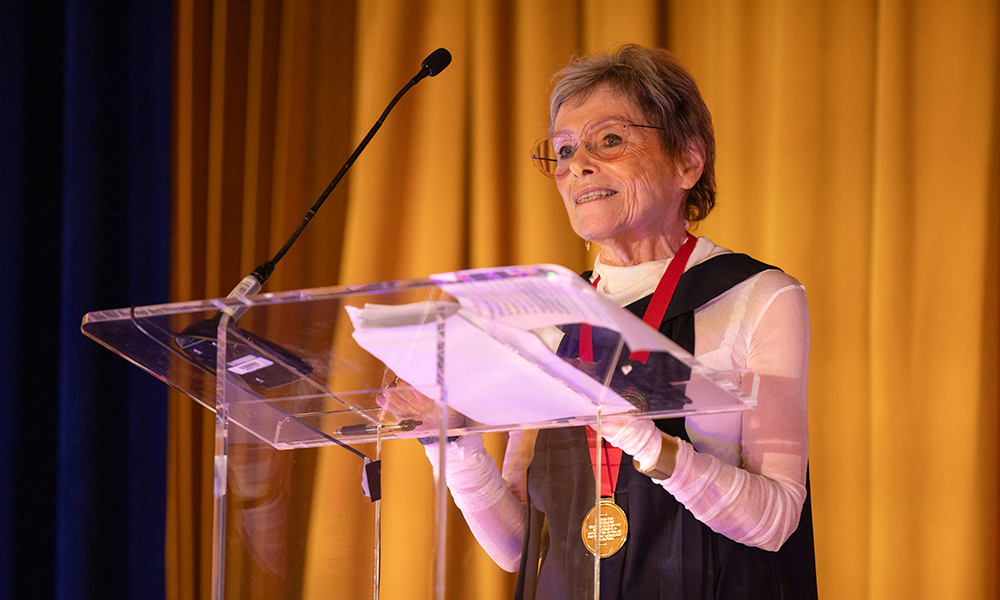 Award presenter handing an award to the recipient at the 2024 SPIE Society Awards Banquet