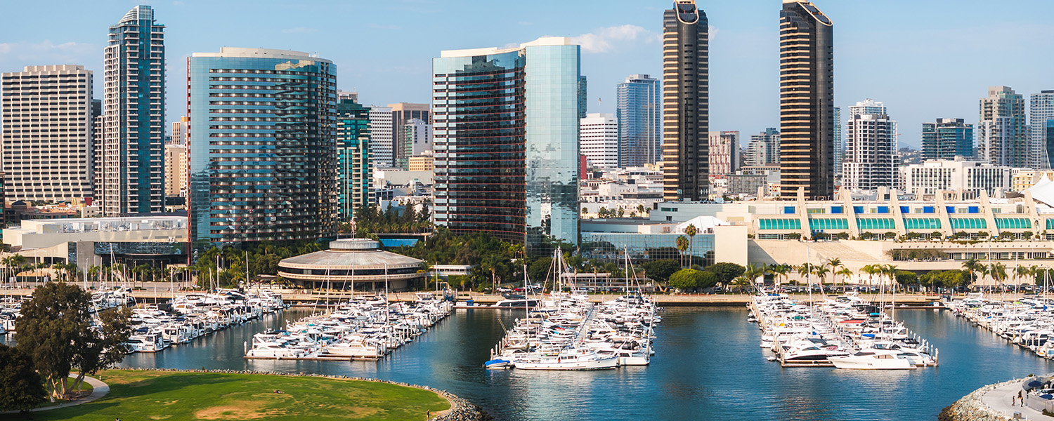A city skyline image of the San Diego Convention Center and marina taken from the water.