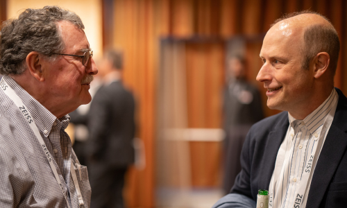 Two male colleagues connect and greet each other