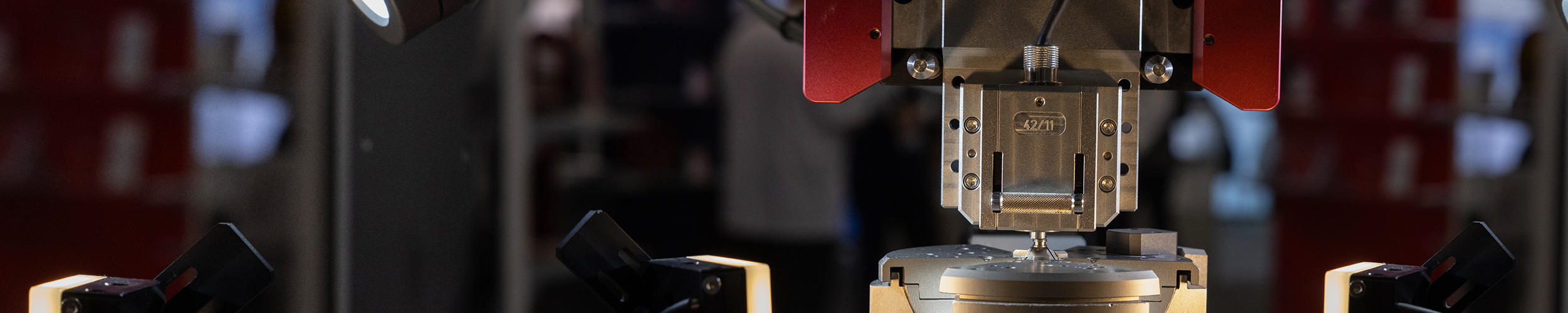 Close up image of metal optical design machinery, labeled 42/11