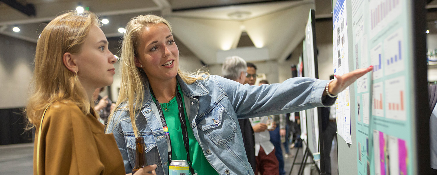 Author explains her research at a poster session at SPIE Optics + Photonics