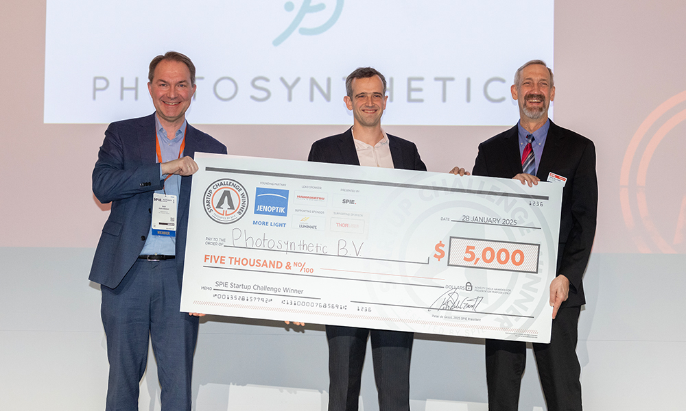 Three individuals holding a large ceremonial check made out to "Photosynthetic B.V." for $5,000, labeled "SPIE Startup Challenge Winner," dated January 28, 2023, with SPIE and Jenoptik logos.