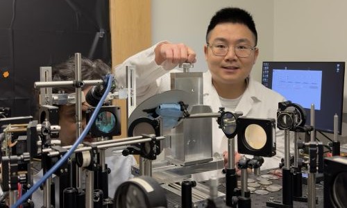 Pupil alignment for ORG imaging: The operator (Teng, right) positions the subject, Dr. Palash Bharadwaj (left), at the patient-friendly ORG system and carefully aligns his pupil with the imaging beam to bring the eye into optimal focus.