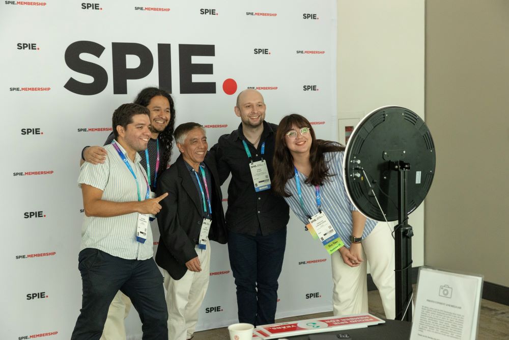 A group poses in an SPIE photo booth