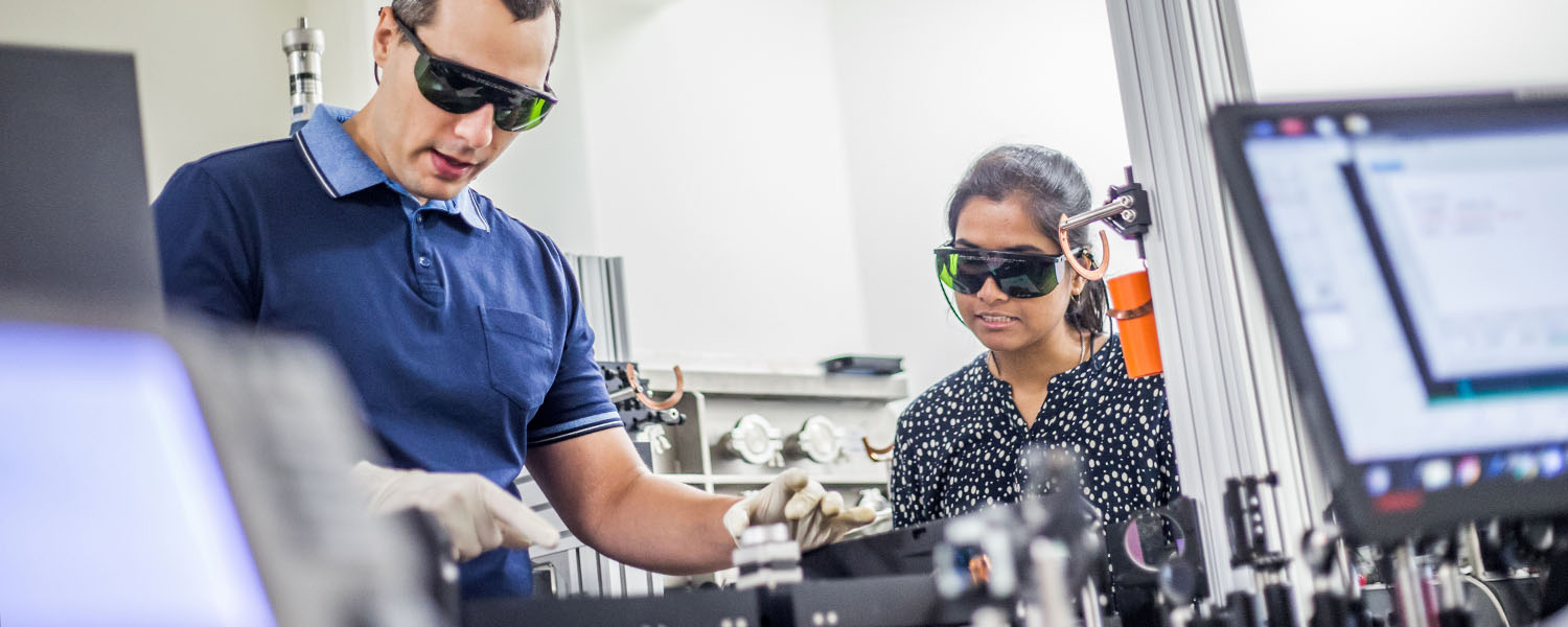 Student and teacher in a laser lab