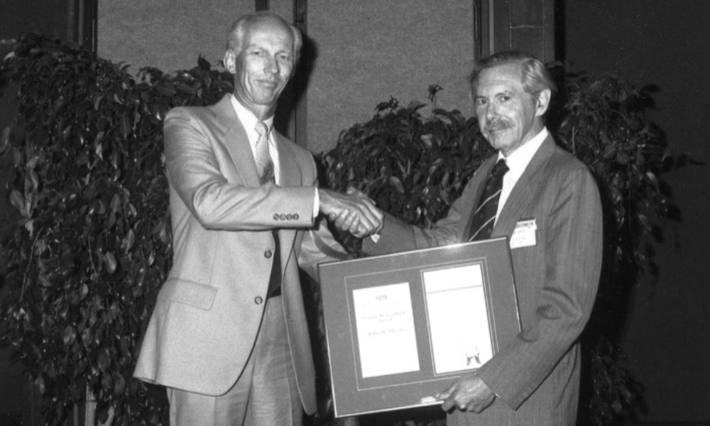 Emery L. Moore, left, presenting the 1989 SPIE George W. Goddard Award in Space and Airborne Optics to recipient John W. Hardy. 