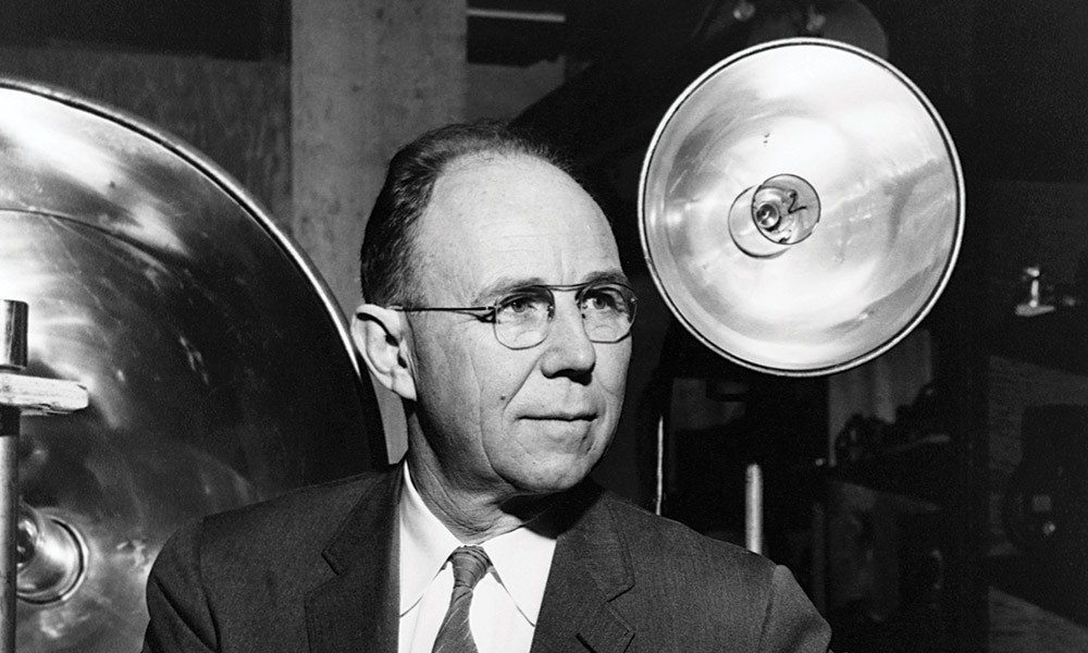 Harold E. Edgerton sits among large lights used for high-speed photography